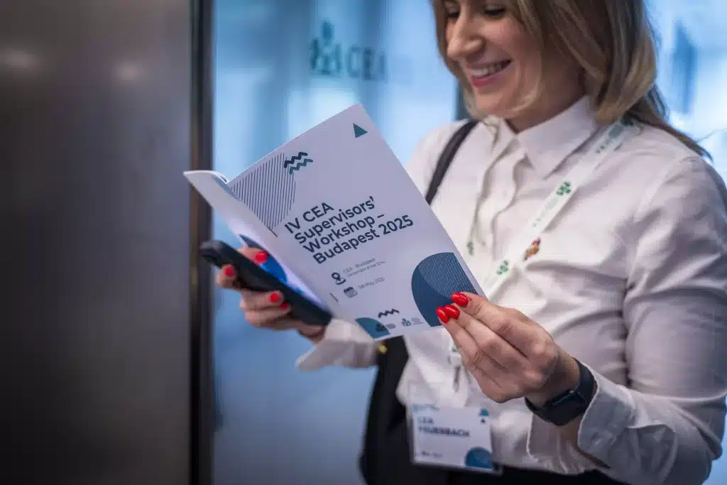 Participant browsing the conference program booklet