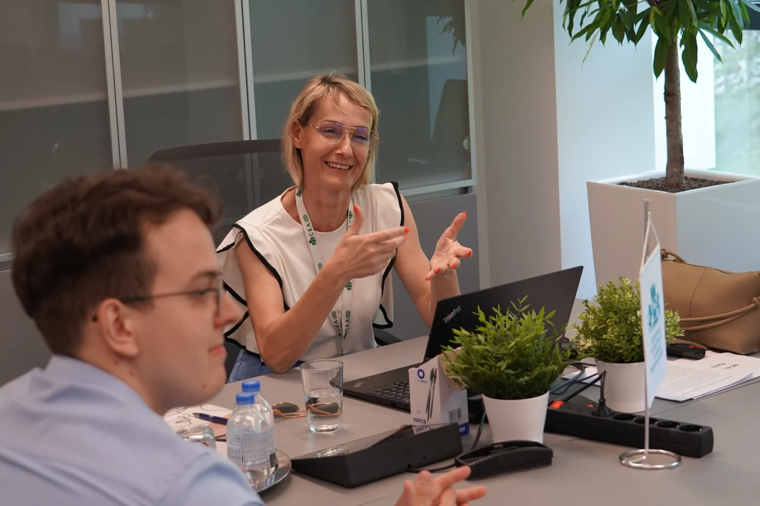 Meeting at the CEA conference table with participants engaged in presentation and discussion