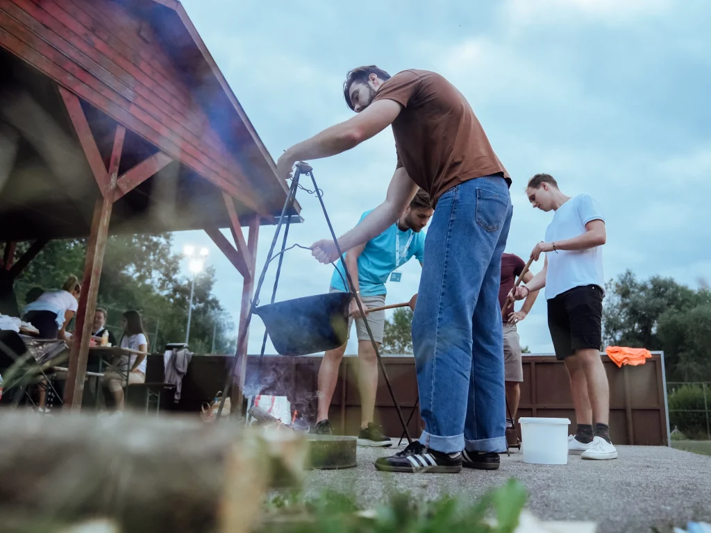Participants cook outdoors