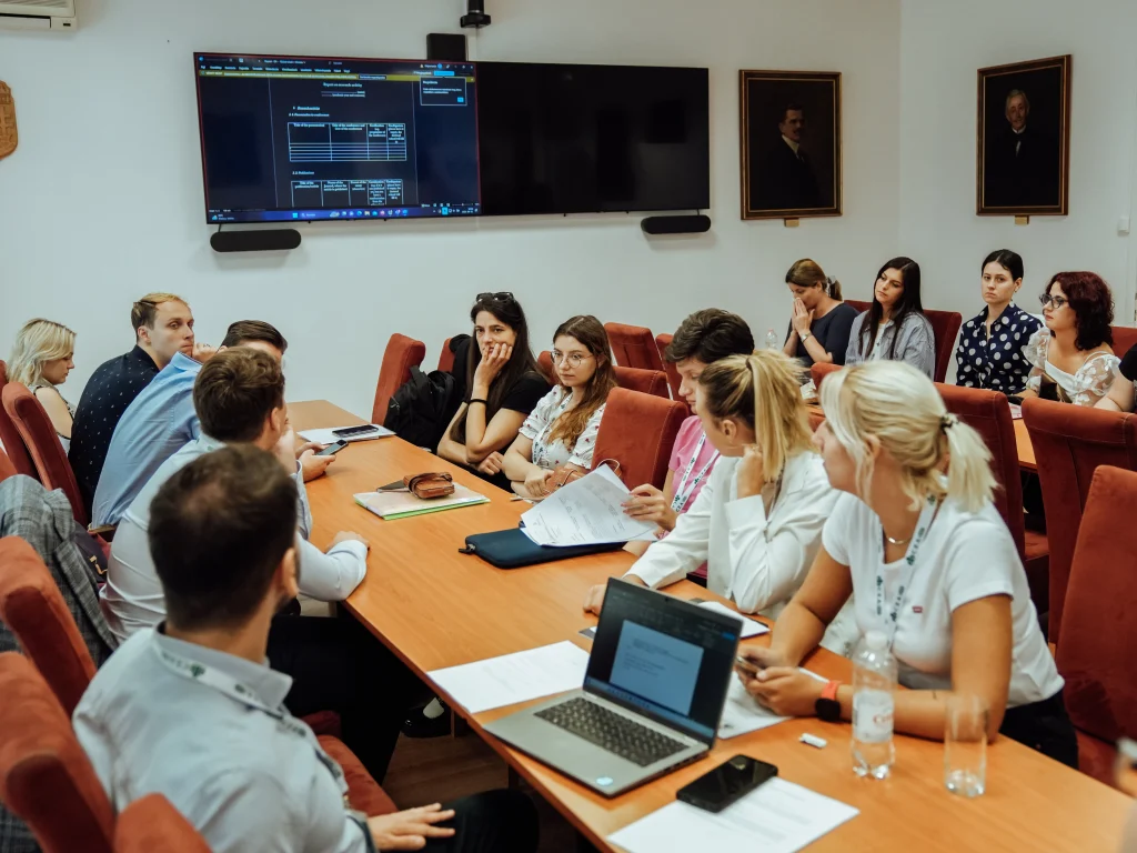 Meeting in a conference room with participants listening to a presentation