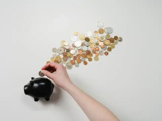 Coins spilling out of a piggy bank
